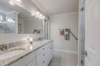 Owner's suite bathroom has double vanities, granite countertops, large marble shower, and a large walk-in closet.