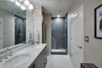 Main Bathroom with double vanities and separate shower and bathtub