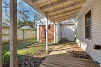 Covered walkway to storage area and backyard