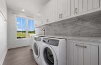 Laundry room with another nook around the corner with shelving for laundry baskets