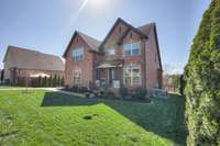 Beautiful landscaping including new flower beds with Muhly Grass, Azaleas, Hydrangea, Boxwood, Crepe Myrtles, Blazing Maple Tree and Fescue grass