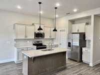 Ample countertop space and cabinet storage are a favorite feature of this kitchen!