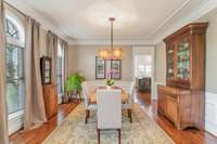 Separate dining room with extensive millwork and updated lighting.