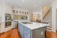 Kitchen features a back staircase leading to upper level.