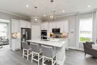 Chef's kitchen includes a granite or quartz countertop, tile backsplash, and SS appliances!