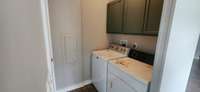 Laundry area with cabinets