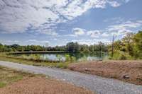 Driveway beside the pond to the building site