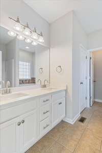 Freshly painted cabinets give your huge master bathroom a modern feel!