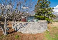 Curved Rock wall seating with in-laid lights making this a cool firepit area.