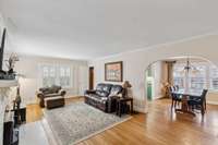 Living Room With Beautiful Original Hardwood Floors & Wood burning Fireplace.