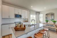 Island countertop has overhang for bar stool seating