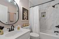 Upstairs bath with tub/shower combo tile surround with single custom vanity and tile flooring