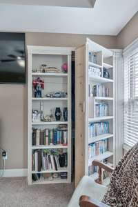 Surprise!!!  Custom bookshelf opens up to the second of 2 walk-in closets