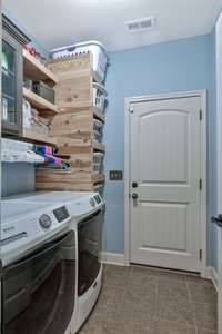 Laundry area off of the garage entry with custom built-ins