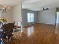 As we step back to the dining/living room area, we are greeted by gleaming floors and a new ceiling fan.