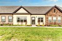 The front side of this "neat as a pin" home is welcoming and faces a large open field!