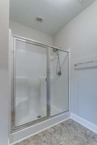 Glass enclosed walk in shower with seating in this primary bath. There are 3 full baths in this home!