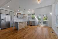 Bright kitchen with doors leading to back deck