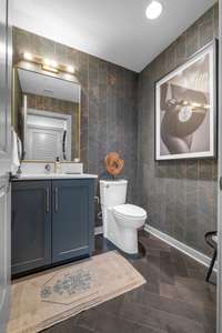 Tastefully wallpapered half bath