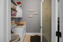 LAUNDRY ROOM WITH CABINETS AND SINK