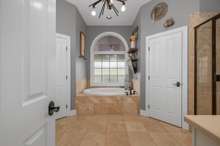 PRIMARY BATHROOM WITH TWO VANITIES, LARGE TUB AND SEPARATE TILE SHOWER