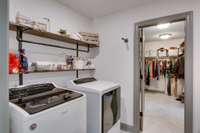 Laundry room that opens to the hallway and then to the primary closet