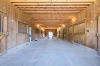 Inside the party barn, the door on the left leads up to the finished studio. This area could be a dedicated workshop, perfect for DIY projects, equipment maintenance or any other hobbyist pursuits.