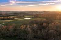 Trails cut through the property, along with two ponds and a creek running through the pastures for year-round water access. There is also a springhouse and one well on the property.