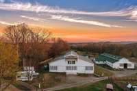 The upper barn, affectionately called the party barn, has concrete floors & an open concrete patio, 10 stalls & the perfect flex space. The upstairs of this 200-year-old barn has been renovated.