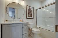 The ensuite bath for Bedroom 2 is light and airy, has a shower/tub combo and plenty of storage space.