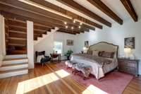 The primary bedroom is the original log cabin believed to be dating back to 1820. During renovations, the ceiling was removed to expose the beams, the fireplace converted to gas & the upstairs is the dressing room/closet.