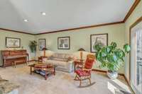 Formal living room with doors to the side deck.