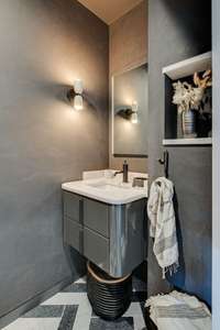 Masculine vibe with Venetian plaster walls and cool lighting and accents.
