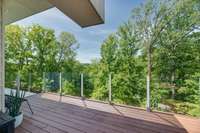 A private terrace off the primary suite bathroom with stunning views of the gorgeous hills and treetops.