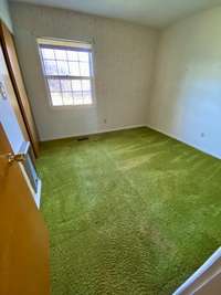 Bedroom 3 with hardwood under carpet