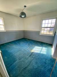 Bedroom 2 with hardwood under carpet