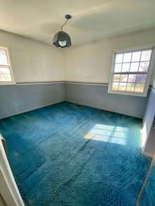 Bedroom 2 with hardwood under carpet