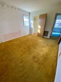 Master bedroom with Hardwood under carpet