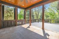 Covered Deck with Custom Shutters for Privacy.  Ceiling Features Bead Board, recessed lighting and ceiling fan with Cedar Columns.