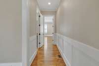 Custom Wainscoting leading you to the first floor Owners Suite.