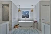 Classy soaking tub and two vanities.