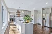 Beautiful and well-arranged kitchen with doors to walk-in pantry and garage.