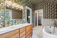 Primary spa like bathroom with double vanities, soak in tub, and separate shower