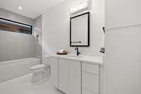 Sleek and modern bath with white quartz countertops