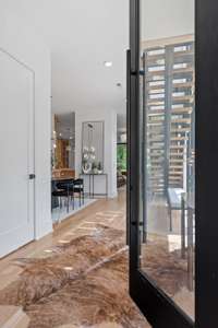 The Custom Steel Pivot door sets the mood for this modern home