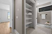 Open shelving in the secondary bath, this bath can also serve the flex space and the office/bedroom on this floor