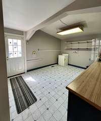 Dining room located adjacent to the kitchen has extra cabinet and counter space.