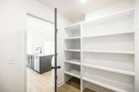 pantry shelving in laundry room provides tons of storage