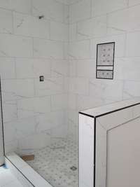Beautiful tiled shower (door and glass on the way)