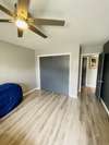 Bedroom has Luxury Vinyl Flooring and a large closet and ceiling fan. Neutral paint throughout.